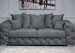 Gray sofa with tufted backrest in a room setting