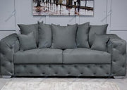 Gray sofa with tufted backrest in a room setting
