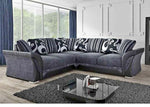 Gray sectional sofa with patterned backrest in a modern living room.