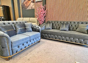 Gray and blue tufted sofas in a room with decorative elements.
