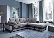 Modern living room with a gray sectional sofa, large windows, and decorative elements.