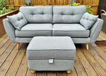 Gray sofa with matching ottoman on a wooden deck