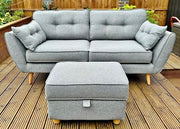 Gray sofa with matching ottoman on a wooden deck