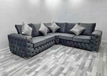 Gray sectional sofa with decorative pillows in a room with gray flooring.