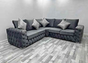 Gray sectional sofa with decorative pillows in a room with gray flooring.