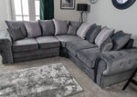 Gray sectional sofa with patterned cushions in a living room setting.