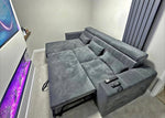Gray sectional sofa in a living room with a TV and decorative items.