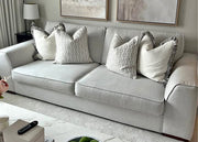Gray sofa with patterned cushions in a living room setting