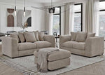 Beige sectional sofa set in a modern living room with large windows.