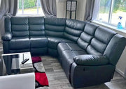 Sectional leather sofa in a living room with a coffee table and rug.