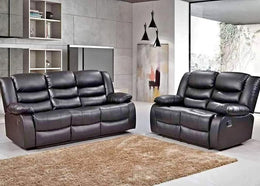Black leather recliner sofa set in a modern living room with a rug and wall art.