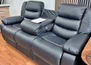 Gray leather recliner sofa with cup holders on a wooden floor.