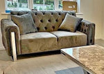 Patterned sofa with decorative pillows in a room with a coffee table.