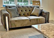Patterned sofa with decorative pillows in a room with a coffee table.