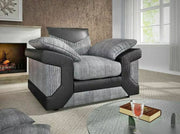 Gray and black armchair in a living room with a fireplace and window.