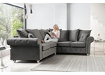 Woman sitting on a gray sectional sofa in a modern living room.
