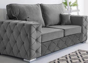 Gray tufted sofa in a room with a patterned rug