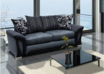 Gray sofa with decorative pillows in a modern living room setting.