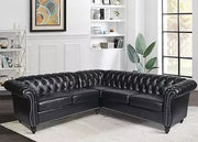 Black leather sectional sofa in a living room setting with decor elements.