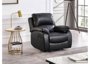 Black leather recliner chair in a modern living room setting with a side table and lamp.