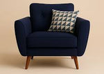 Navy blue armchair with a patterned pillow on a beige background