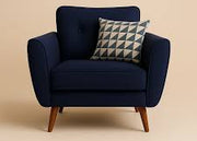 Navy blue armchair with a patterned pillow on a beige background