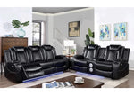 Black leather sectional sofa in a living room setting with a coffee table and decor.