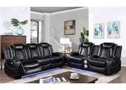 Black leather sectional sofa in a living room setting with a coffee table and decor.