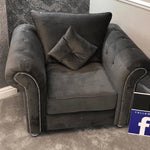 Gray armchair with a pillow in a room setting