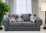 Gray sofa with plaid cushions in a living room setting